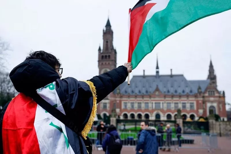 a man waves a palestinian flag as people protest in the hague netherlands february 21 2024 photo reuters a man waves a palestinian flag as people protest in the hague netherlands february 21 2024 photo reuters