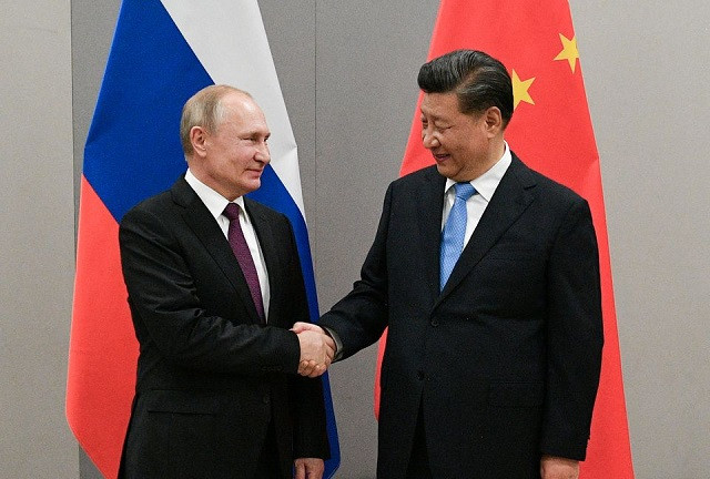 russian president vladimir putin shakes hands with chinese president xi jinping during their meeting on the sidelines of a brics summit in brasilia brazil november 13 2019 photo reuters