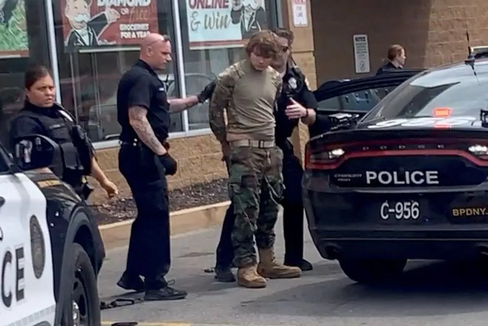 a man is detained following a mass shooting in the parking lot of tops supermarket in a still image from a social media video in buffalo new york u s may 14 2022 courtesy of bigdawg via reuters a man is detained following a mass shooting in the parking lot of tops supermarket in a still image from a social media video in buffalo new york u s may 14 2022 courtesy of bigdawg via reuters