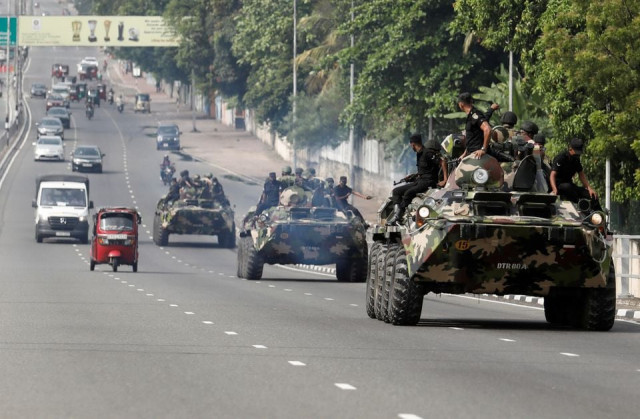 army members travel on armoured cars on the main road after the curfew was extended for another extra day following a clash between anti government demonstrators and sri lanka s ruling party supporters amid the country s economic crisis in colombo sri lanka may 11 2022 reuters army members travel on armoured cars on the main road after the curfew was extended for another extra day following a clash between anti government demonstrators and sri lanka s ruling party supporters amid the country s economic crisis in colombo sri lanka may 11 2022 reuters