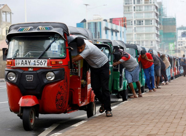 drivers push auto rickshaws in a line to buy petrol from a fuel station amid sri lanka s economic crisis in colombo sri lanka july 29 2022 reuters drivers push auto rickshaws in a line to buy petrol from a fuel station amid sri lanka s economic crisis in colombo sri lanka july 29 2022 reuters