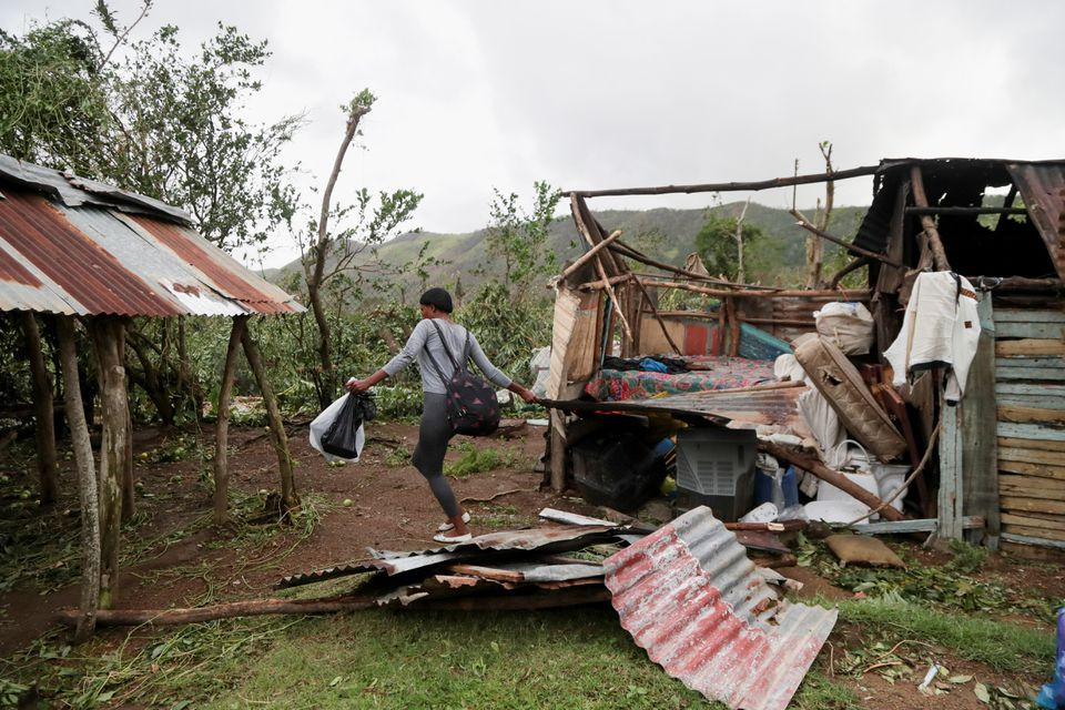 a woman removes rubble from her destroyed house in the rural zone of cuey in the aftermath of hurricane fiona in el seibo dominican republic september 20 2022 reuters ricardo rojas