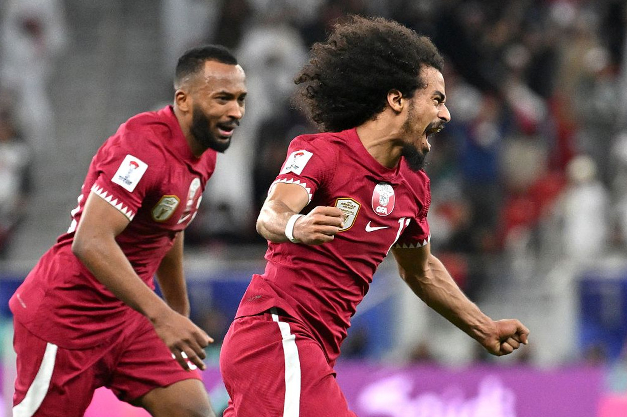 qatar s akram afif no 11 celebrates scoring his team s second goal during the qatar 2023 afc asian cup semi final football match against iran at al thumama stadium in doha photo afp