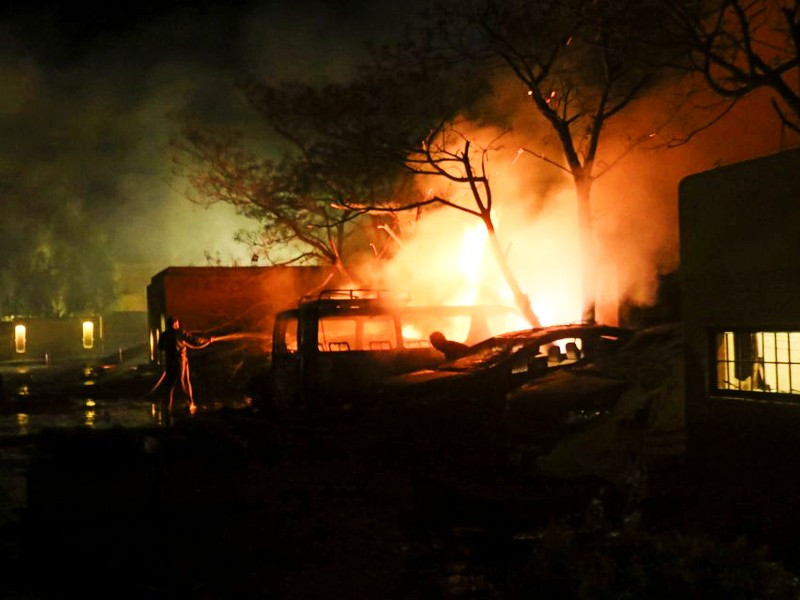 a fireman douses burning vehicles after an explosion at a luxury hotel in quetta pakistan april 21 2021 photo reuters