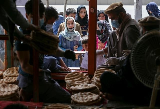 an afghan family waits for free bread distributed by the government outside a bakery during the coronavirus disease covid 19 outbreak in kabul afghanistan may 3 2020 picture taken may 3 2020 photo reuters an afghan family waits for free bread distributed by the government outside a bakery during the coronavirus disease covid 19 outbreak in kabul afghanistan may 3 2020 picture taken may 3 2020 photo reuters