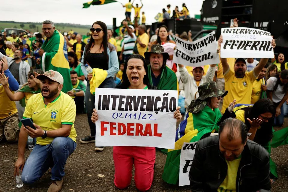 people attend a protest over brazil s president jair bolsonaro s defeat in the presidential run off election in anapolis goias state brazil november 2 2022 signs read federal intervention reuters ueslei marcelino people attend a protest over brazil s president jair bolsonaro s defeat in the presidential run off election in anapolis goias state brazil november 2 2022 signs read federal intervention reuters ueslei marcelino