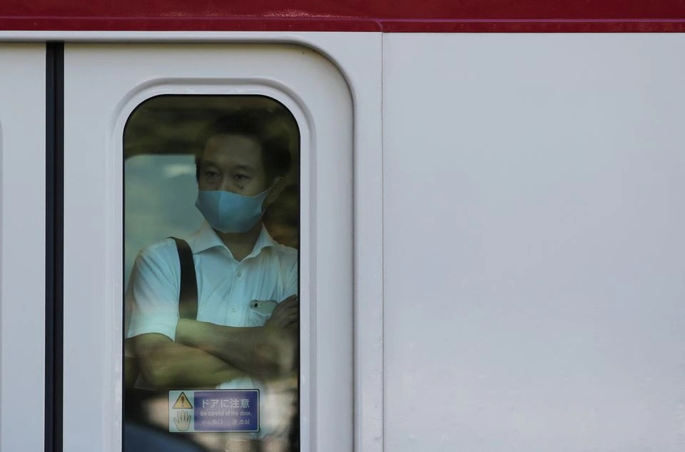 a man wearing a protective mask rides a train amid the coronavirus disease covid 19 outbreak in tokyo japan august 10 2021 photo reuters