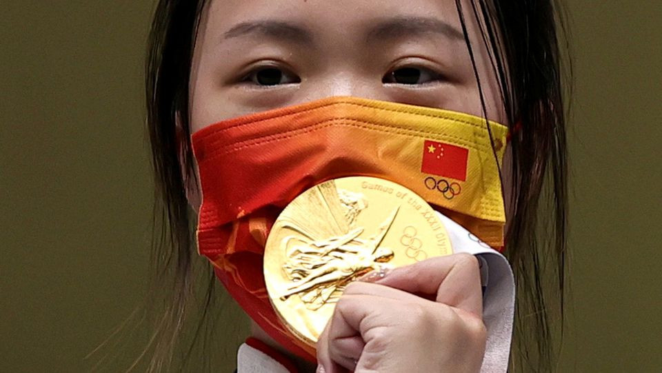 tokyo 2020 olympics   shooting   women s 10m air rifle   medal ceremony   asaka shooting range tokyo japan july 24 2021 gold medallist yang qian of china celebrates on the podium photo reuters