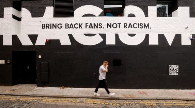 a man walks past sport related anti racism graffiti on the side of a building in london britain june 10 2021 photo reuters a man walks past sport related anti racism graffiti on the side of a building in london britain june 10 2021 photo reuters