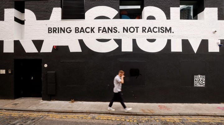 a man walks past sport related anti racism graffiti on the side of a building in london britain june 10 2021 photo reuters