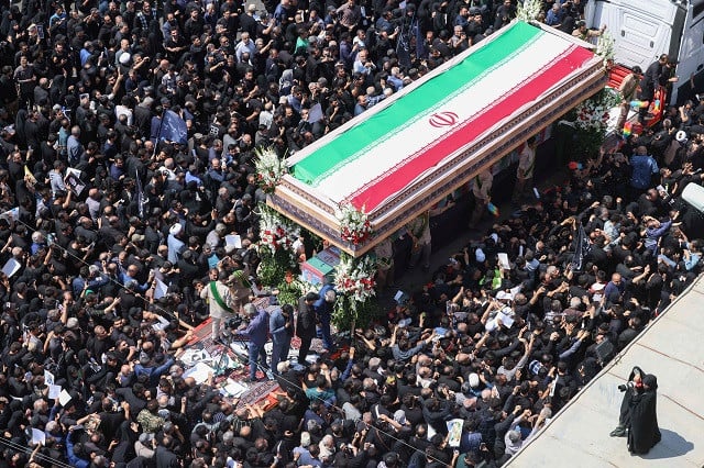 mourners attend the funeral of iran s president ebrahim raisi in tehran on may 22 2024 huge crowds of iranians thronged the streets of the capital tehran on may 22 for the funeral procession of president ebrahim raisi and his entourage who died in a helicopter crash photo afp