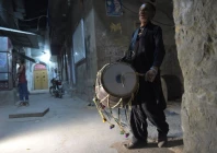 lal hussain 66 ramazan drummer beats his drum as he makes calls at doors at bani an old residential area in rawalpindi photo afp