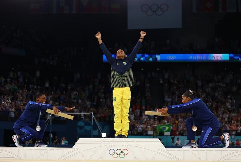 rebeca andrade of brazil celebrates on the podium with silver medallist simone biles of united states and bronze medallist jordan chiles of united states photo reuters