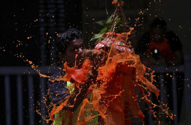 a devotee breaks a clay pot containing curd during the hindu festival of janmashtami marking the birth anniversary of hindu lord krishna in mumbai reuters a devotee breaks a clay pot containing curd during the hindu festival of janmashtami marking the birth anniversary of hindu lord krishna in mumbai reuters