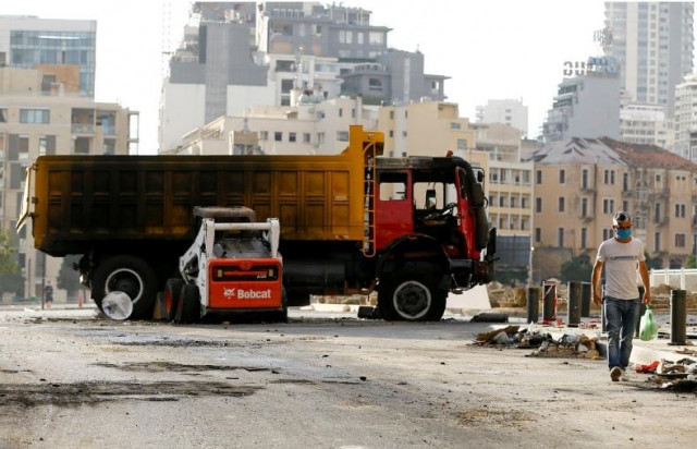 a man walks past a truck that was burned during a protest in martyrs square following tuesday s blast in beirut lebanon photo reuters
