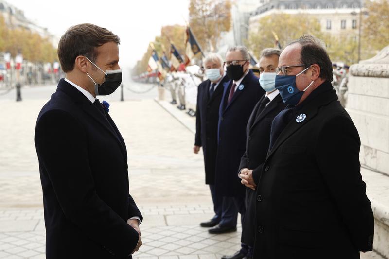 french president emmanuel macron salutes french former president francois hollande as he attends a ceremony at the arc de triomphe in paris france november 11 2020 photo reuters
