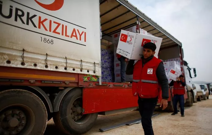 turkish red crescent workers carry humanitarian aid at kelbit camp near the syrian turkish border in idlib province syria photo reuters file