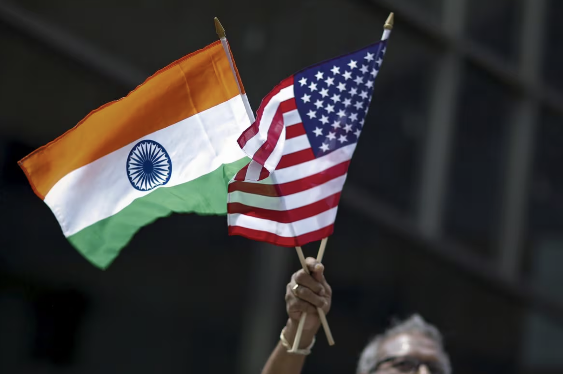 photo a man holds the flags of india and the u s while people take part in the 35th india day parade in new york august 16 2015 reuters