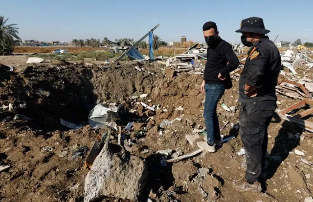 photo a fighter of the iraqi kataib hezbollah militia group and a man inspect the site of a u s airstrike in hilla iraq december 26 2023 reuters photo a fighter of the iraqi kataib hezbollah militia group and a man inspect the site of a u s airstrike in hilla iraq december 26 2023 reuters
