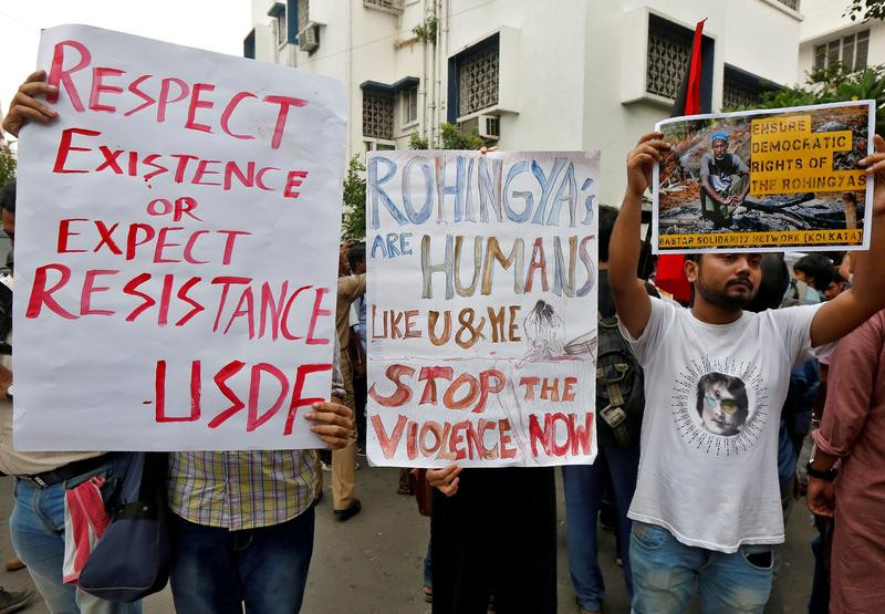 people hold placards during a protest rally against what the protesters say are killings of rohingya people in myanmar in front of myanmar consulate in kolkata india photo reuters