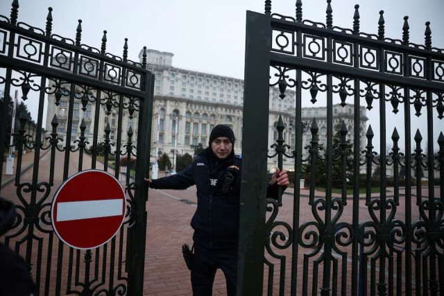 a jandarmeria member closes a gate to the palace of parliament after the romanian top court annulled the result of the first round of the presidential election in bucharest romania on december december 6 photo reuters a jandarmeria member closes a gate to the palace of parliament after the romanian top court annulled the result of the first round of the presidential election in bucharest romania on december december 6 photo reuters
