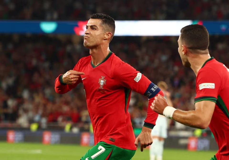 portugal s cristiano ronaldo celebrates scoring their second goal with diogo dalot during nations league s league a group 1 portugal vs scotland match at estadio da luz lisbon portugal on september 8 2024 photo reuters