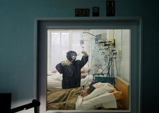 a medical specialist wearing protective gear takes care of a patient at the intensive care unit of the vologda city hospital number 1 where patients suffering from the coronavirus disease covid 19 are treated in vologda russia photo reuters a medical specialist wearing protective gear takes care of a patient at the intensive care unit of the vologda city hospital number 1 where patients suffering from the coronavirus disease covid 19 are treated in vologda russia photo reuters