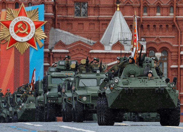 Russian service members ride on armoured vehicles during a military parade on Victory Day. PHOTO: Reuters