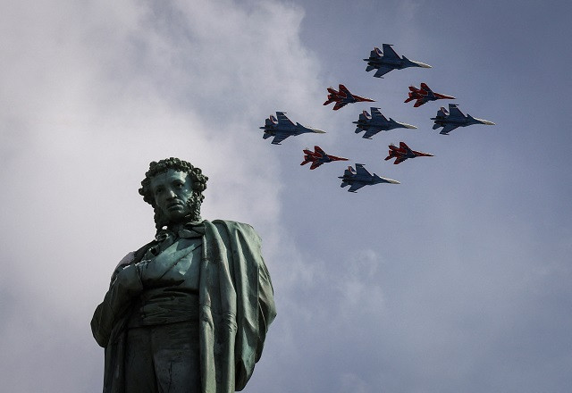 Russian MiG-29 jet fighters of the Strizhi (Swifts) and Su-30SM jet fighters of the Russkiye Vityazi (Russian Knights) aerobatic teams fly in formation over the monument to Russian poet Alexander Pushkin during a flypast and a military parade on Victory Day. PHOTO: Reuters