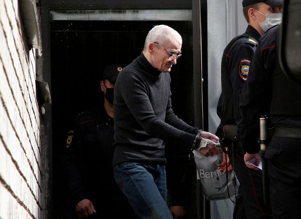 russian historian yuri dmitriev who was charged with sexually abusing his adopted daughter is escorted by police officers after a court hearing in petrozavodsk russia july 22 2020 in this screen grab taken from a video photo reuters