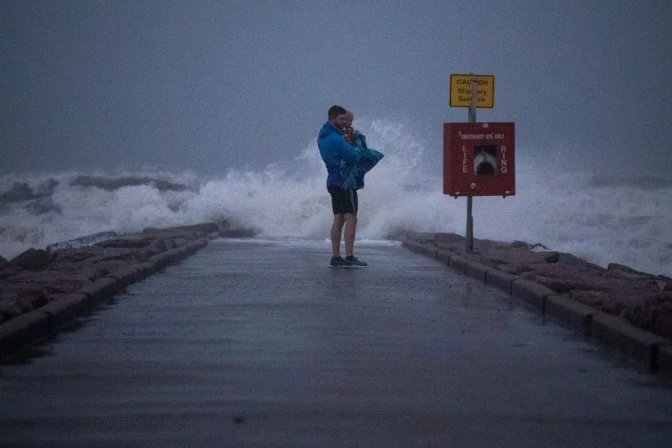 local resident john smith holds his 18 month old son owen as he stands near breaking waves on a pier ahead of the arrival of tropical storm nicholas in galveston texas u s september 13 2021 photo reuters local resident john smith holds his 18 month old son owen as he stands near breaking waves on a pier ahead of the arrival of tropical storm nicholas in galveston texas u s september 13 2021 photo reuters