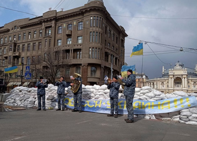 ukrainian navy musicians perform in front of barricade made of sandbags near the opera theatre in central odessa ukraine march 8 2022 reuters