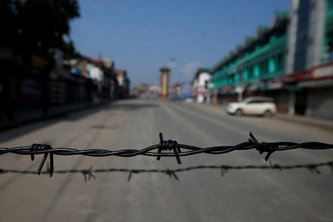 barbed wire is seen laid on a deserted road during restrictions in srinagar photo reuters