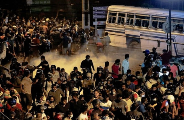 demonstrators move away from tear gas used by the police near sri lankan president gotabaya rajapaksa s residence during a protest against him as many parts of the crisis hit country faced up to 13 hours without electricity due to a shortage of foreign currency to import fuel in colombo sri lanka march 31 2022 photo reuters