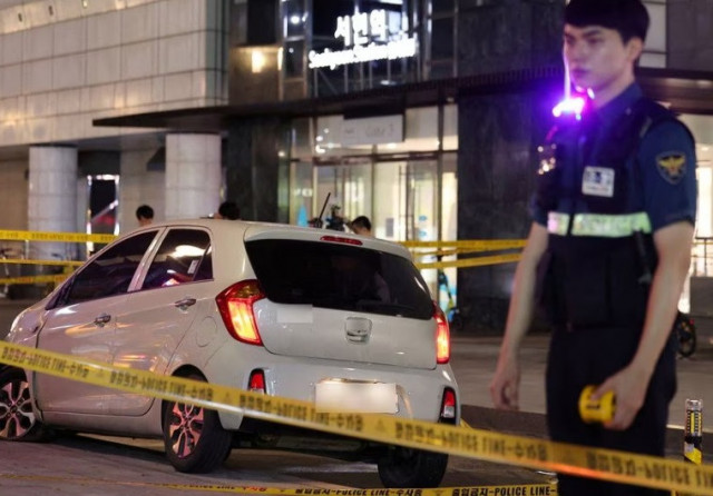 a policeman stands next to a scene where according to media reports nine people have been stabbed and four others hurt by a car driven by the suspected attacker in seongnam south korea august 3 2023 yonhap via reuters a policeman stands next to a scene where according to media reports nine people have been stabbed and four others hurt by a car driven by the suspected attacker in seongnam south korea august 3 2023 yonhap via reuters