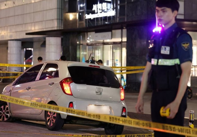 a policeman stands next to a scene where according to media reports nine people have been stabbed and four others hurt by a car driven by the suspected attacker in seongnam south korea august 3 2023 yonhap via reuters