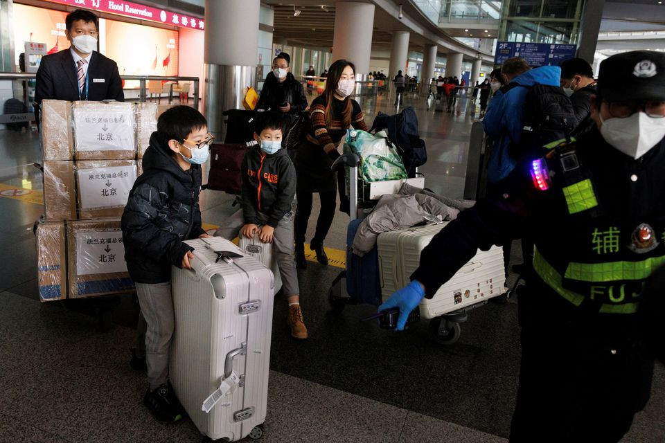 passengers push their luggage through the international arrivals hall at beijing capital international airport after china lifted the coronavirus disease covid 19 quarantine requirement for inbound travellers in beijing china january 8 2023 photo reuters