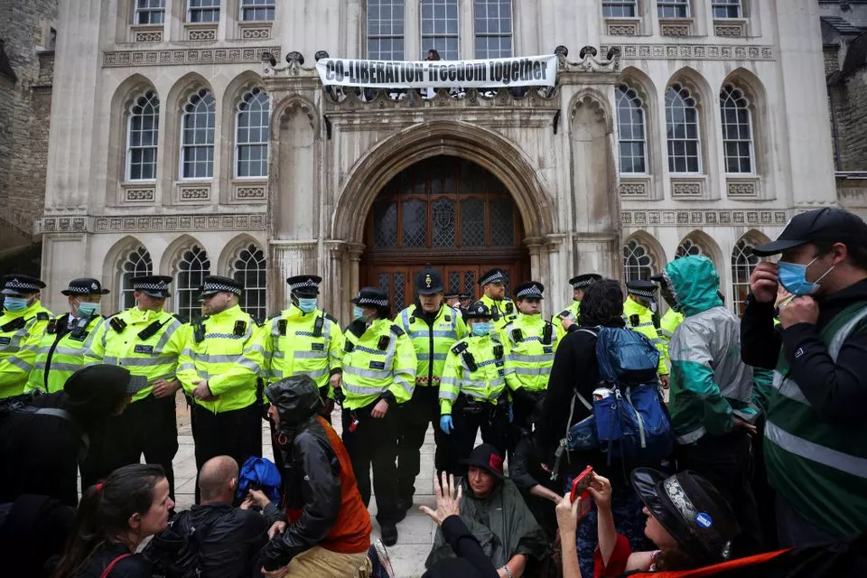 police officers stand in formation as extinction rebellion climate activists protest at the guildhall in london britain august 22 2021 photo reuters police officers stand in formation as extinction rebellion climate activists protest at the guildhall in london britain august 22 2021 photo reuters