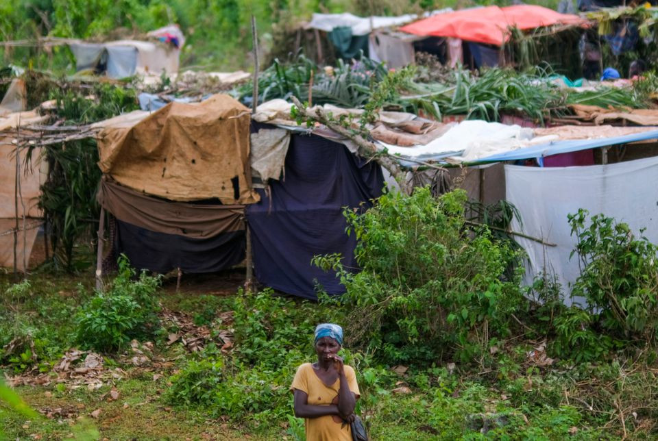 a woman stands in front of a tent encampment built after the august 14 earthquake destroyed houses and infrastructure in the nan konsey neighborhood of pestel haiti august 23 2021 picture taken august 23 2021 photo reuters