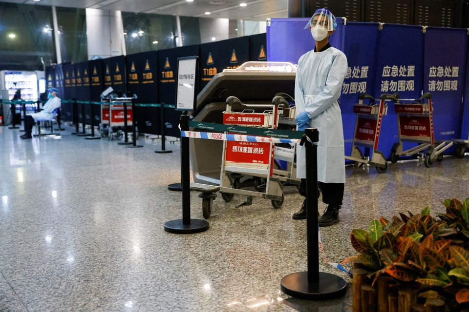 A security member stands outside the area where relatives of the passengers of the China Eastern Airlines Boeing 737-800 plane, which crashed in Wuzhou flying from Kunming to Guangzhou, wait for news, at Guangzhou Baiyun International Airport in Guangzhou, Guangdong province, China March 21, 2022. REUTERS