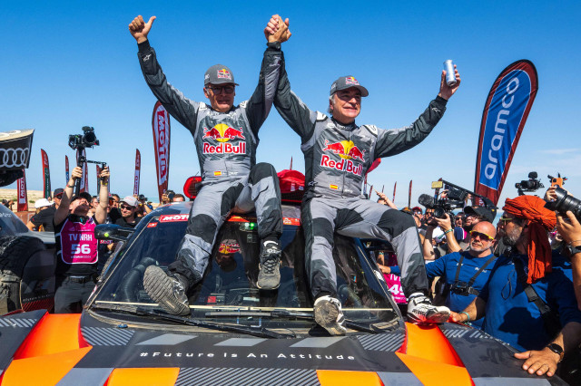 team audi sport s spanish driver carlos sainz r and his co driver lucas cruzof celebrate their victory in dakar rally on friday photo afp