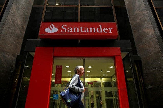 a woman walks past a banco santander branch in downtown rio de janeiro august 19 2014 photo reuters