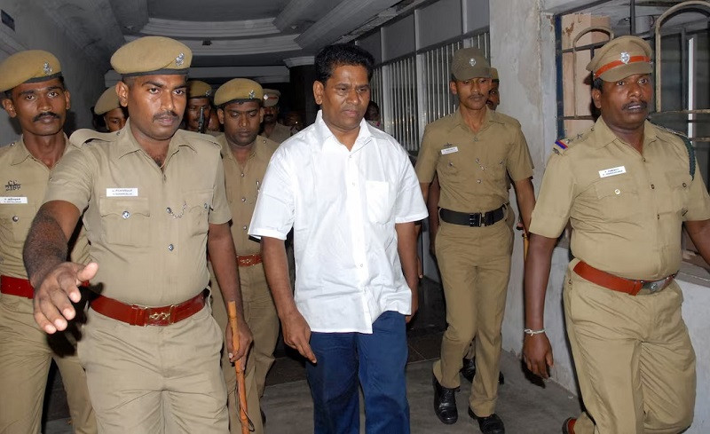Santiago Martin, an Indian businessman, is escorted by police officers as he arrives to appear before a court in Coimbatore, India, September 8, 2011. PHOTO: REUTERS