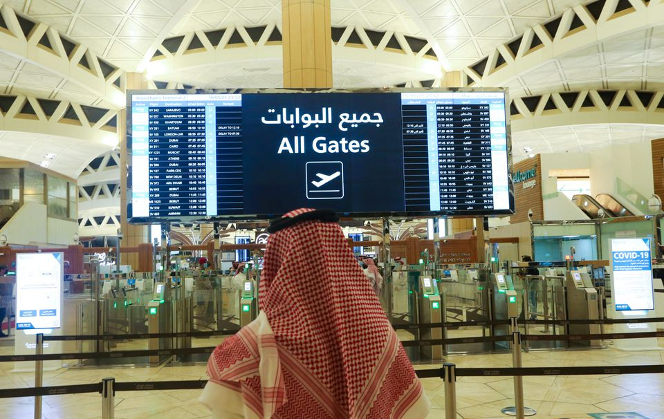 a saudi man checks the flight timings at the king khalid international airport after saudi authorities lifted the travel ban on its citizens after fourteen months due to coronavirus disease covid 19 restrictions in riyadh saudi arabia may 16 2021 photo reuters