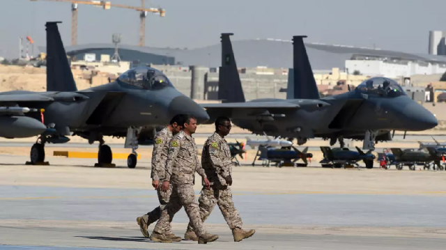 saudi military officers walk past f 15 fighter jets gbu bombs and missiles displayed during a ceremony marking the 50th anniversary of the creation of the king faisal air academy at king salman airbase in riyadh in 2017 photo afp saudi military officers walk past f 15 fighter jets gbu bombs and missiles displayed during a ceremony marking the 50th anniversary of the creation of the king faisal air academy at king salman airbase in riyadh in 2017 photo afp