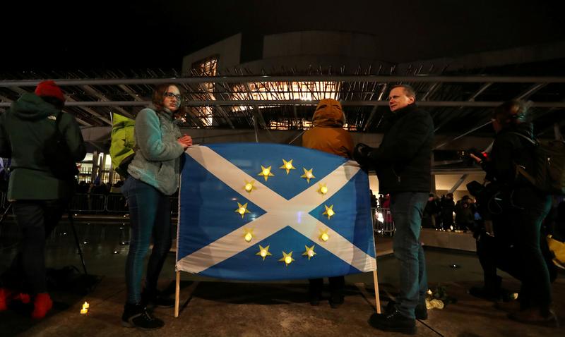 people hold a scottish flag featuring the stars of the european union flag as they gather on the streets on brexit day in edinburgh scotland britain january 31 2020 photo reuters