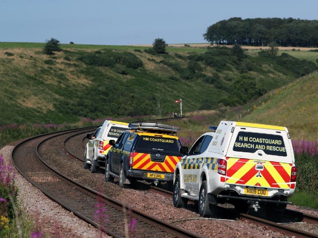 emergency services vehicles ride along the tracks near the scene of a derailed passenger train near carmont stonehaven scotland britain photo reuters