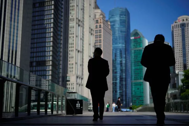 people walk by office towers in the lujiazui financial district of shanghai china october 17 2022 photo reuters aly song file photo people walk by office towers in the lujiazui financial district of shanghai china october 17 2022 photo reuters aly song file photo