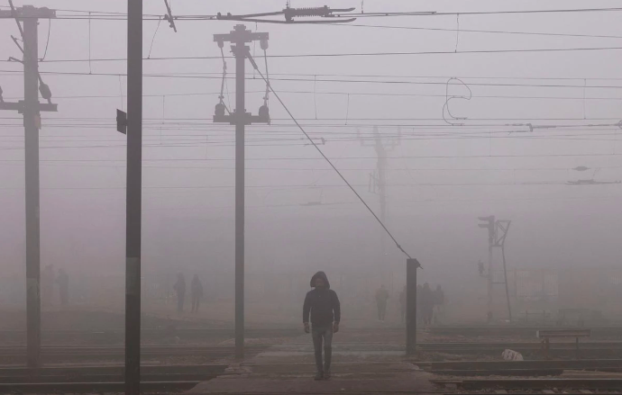 a man crosses railway tracks amidst heavy fog on a cold winter morning in new delhi india january 9 2023 photo reuters anushree fadnavis