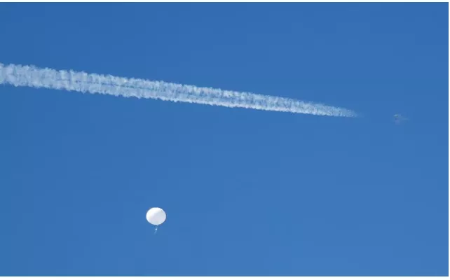 a jet flies by a suspected chinese spy balloon as it floats off the coast in surfside beach south carolina u s february 4 2023 photo reuters randall hill